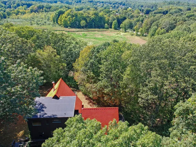 an aerial view of a house with a yard and outdoor seating