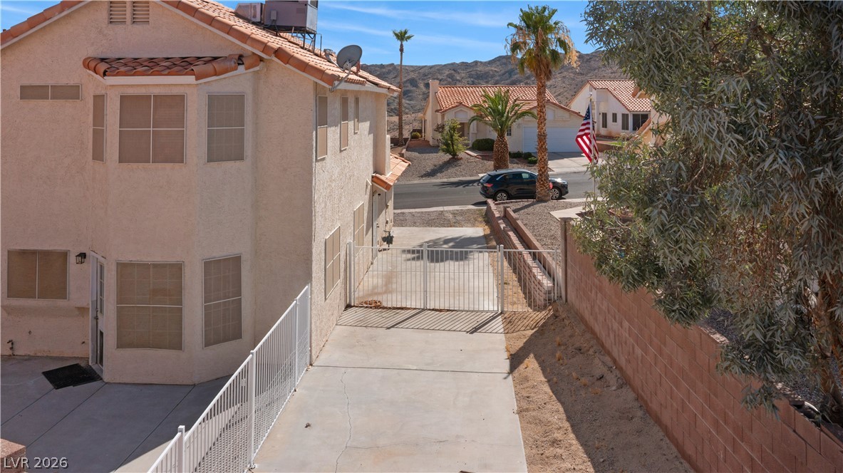 3156 Terrace View Drive Laughlin, NV 89029 - Photo 83 of 94 A terracotta tile roof accents this two-story stucco residence with desert landscaping.