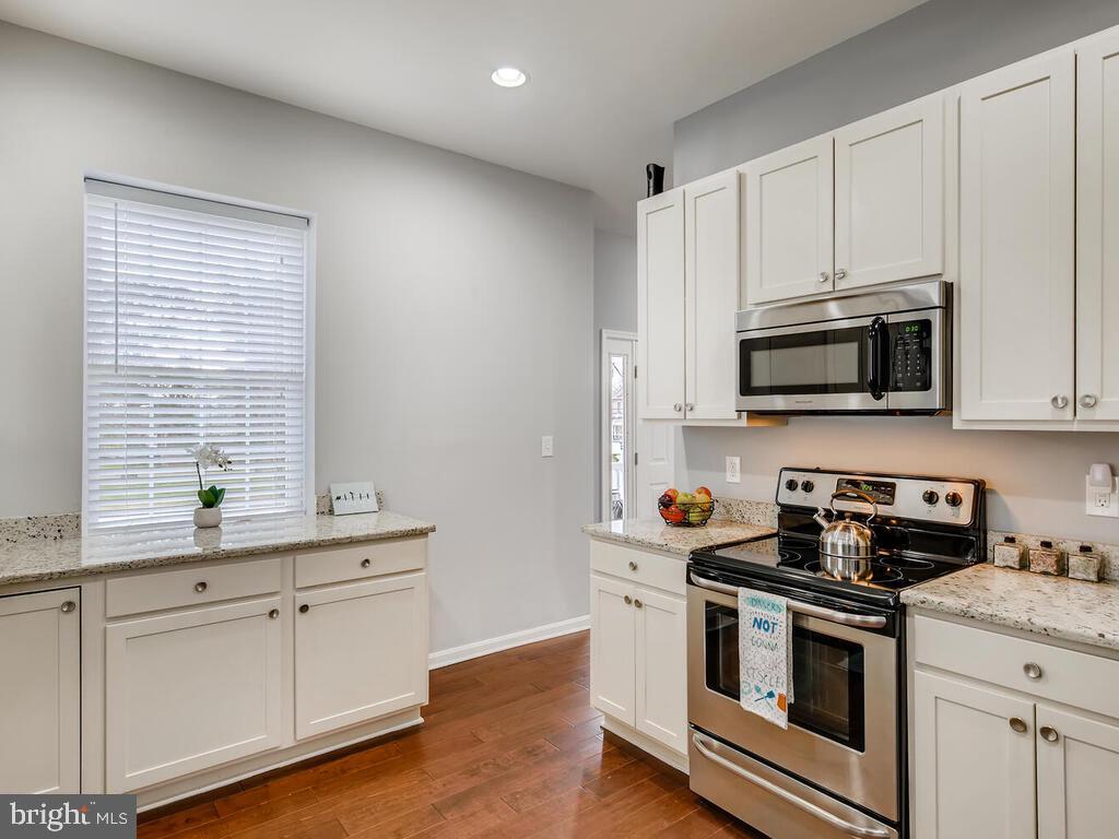 509 Middle River Road Baltimore, MD 21220 - Photo 13 of 37 KITCHEN w/GRANITE, RECESSED LIGHTING, HARDWOODS