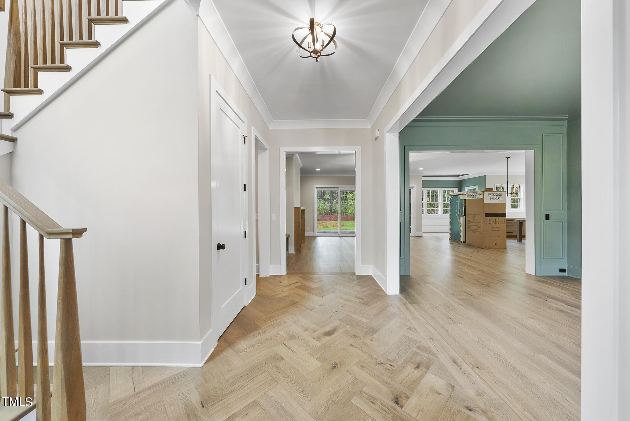 1409 Starry Night Court Raleigh, NC 27613 - Photo 3 of 35 a view of a hallway view with wooden floor and staircase