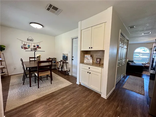 a view of kitchen with cabinets and wooden floor