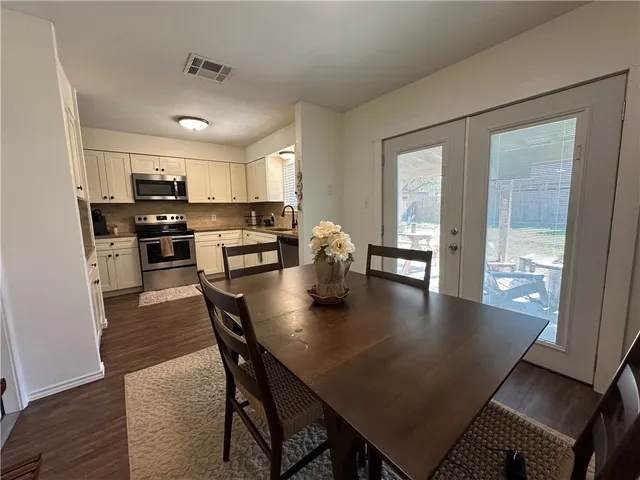 a view of kitchen dining table and chairs