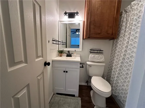 a bathroom with a sink toilet and mirror