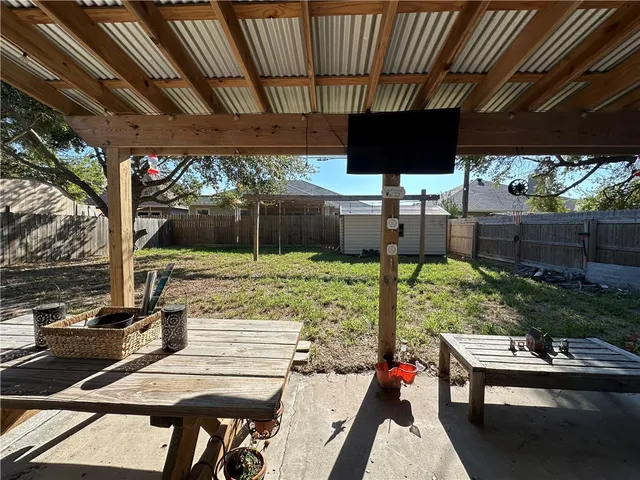 a view of yard from deck with patio