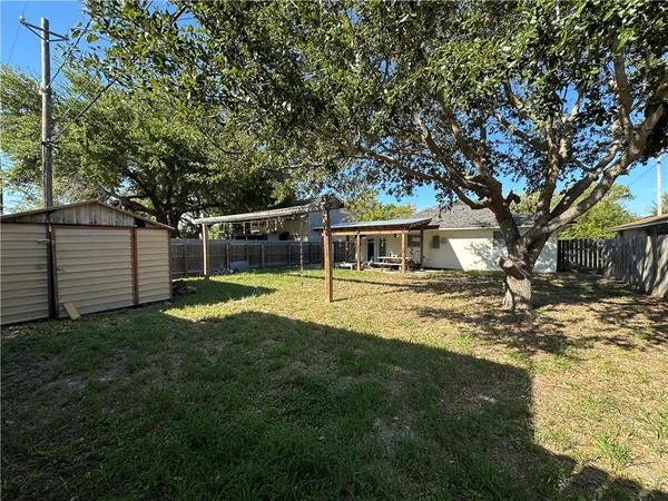 a view of house with backyard