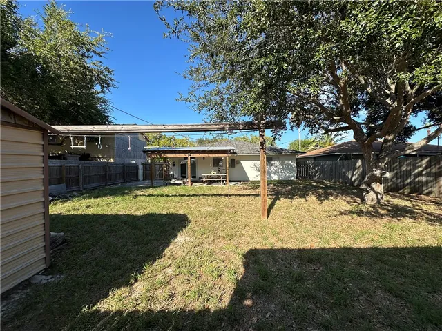 a view of house with yard covered with snow in the background