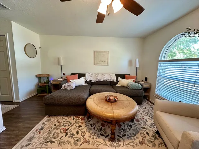 a living room with furniture a rug and a window