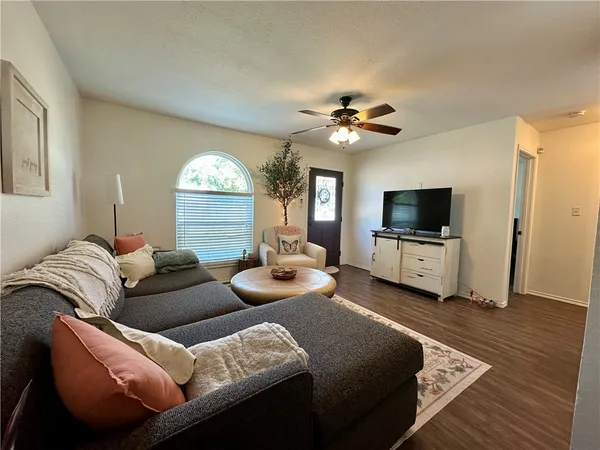 a living room with furniture and a flat screen tv
