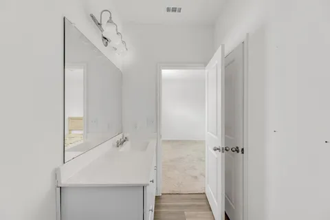 a bathroom with a sink and mirror