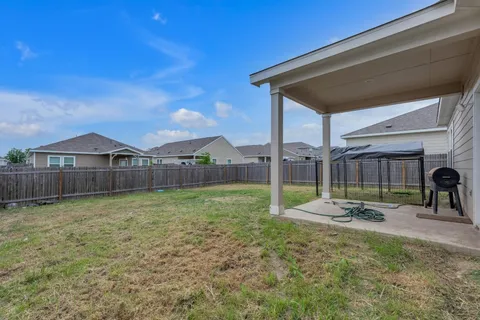 a view of a house with backyard and sitting area
