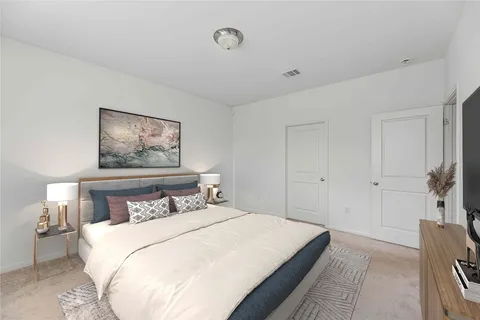 a bedroom with a bed and a painting on the wall