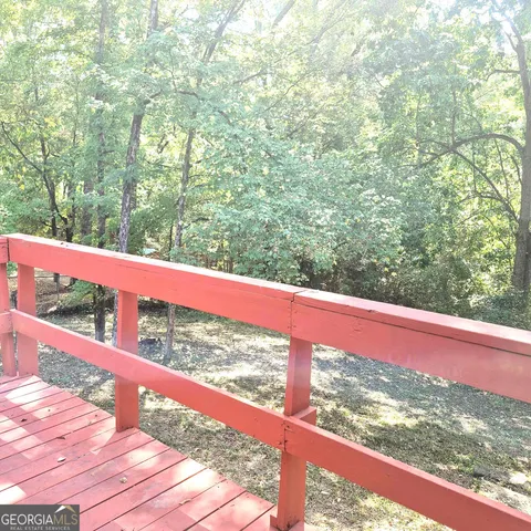 wooden floor fireplace and windows in an empty room