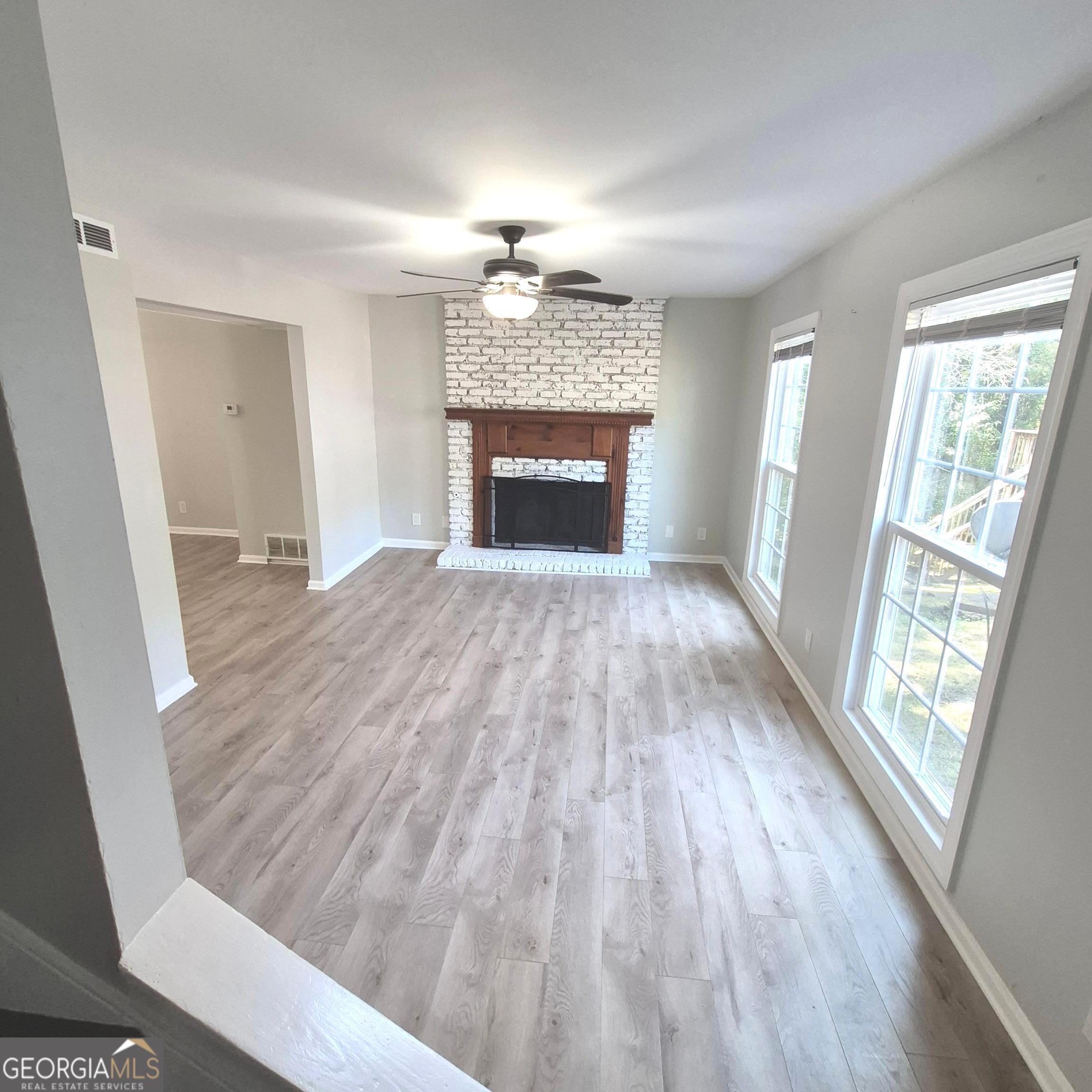 195 Springdale Court Macon, GA 31210 - Photo 4 of 14 wooden floor fireplace and windows in an empty room