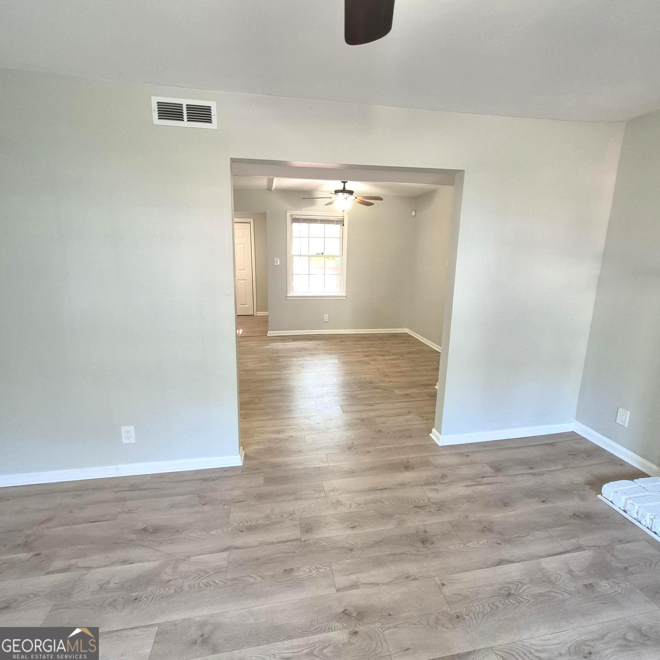 195 Springdale Court Macon, GA 31210 - Photo 5 of 14 a view of empty room with wooden floor and fan