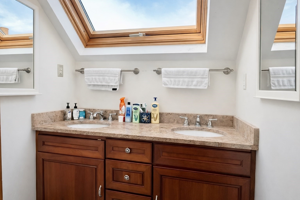 53 Hillside Street, Unit 3 Boston, MA 02120 - Photo 9 of 10 a bathroom with a granite countertop sink and a mirror