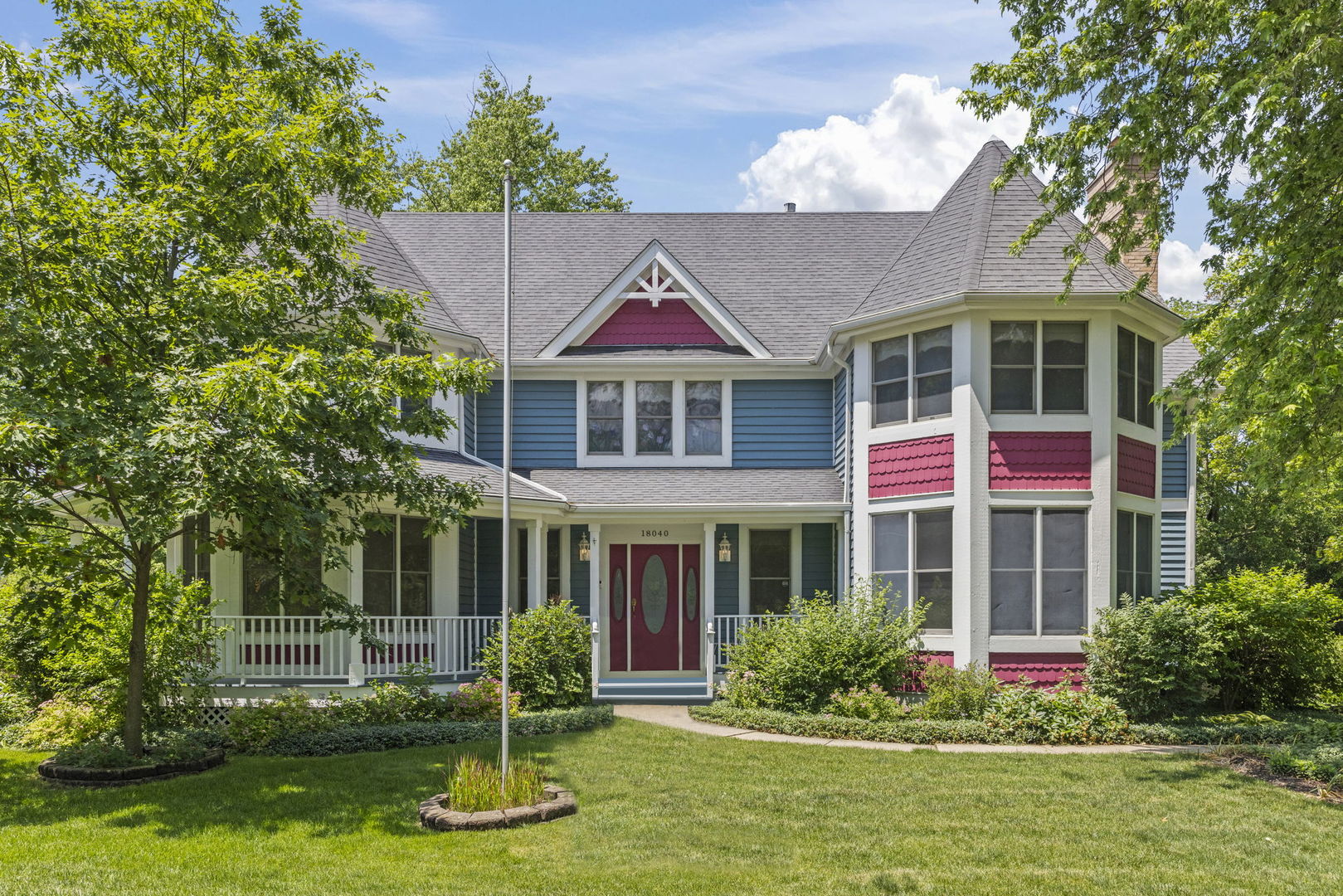 a front view of a house with a yard table and chairs