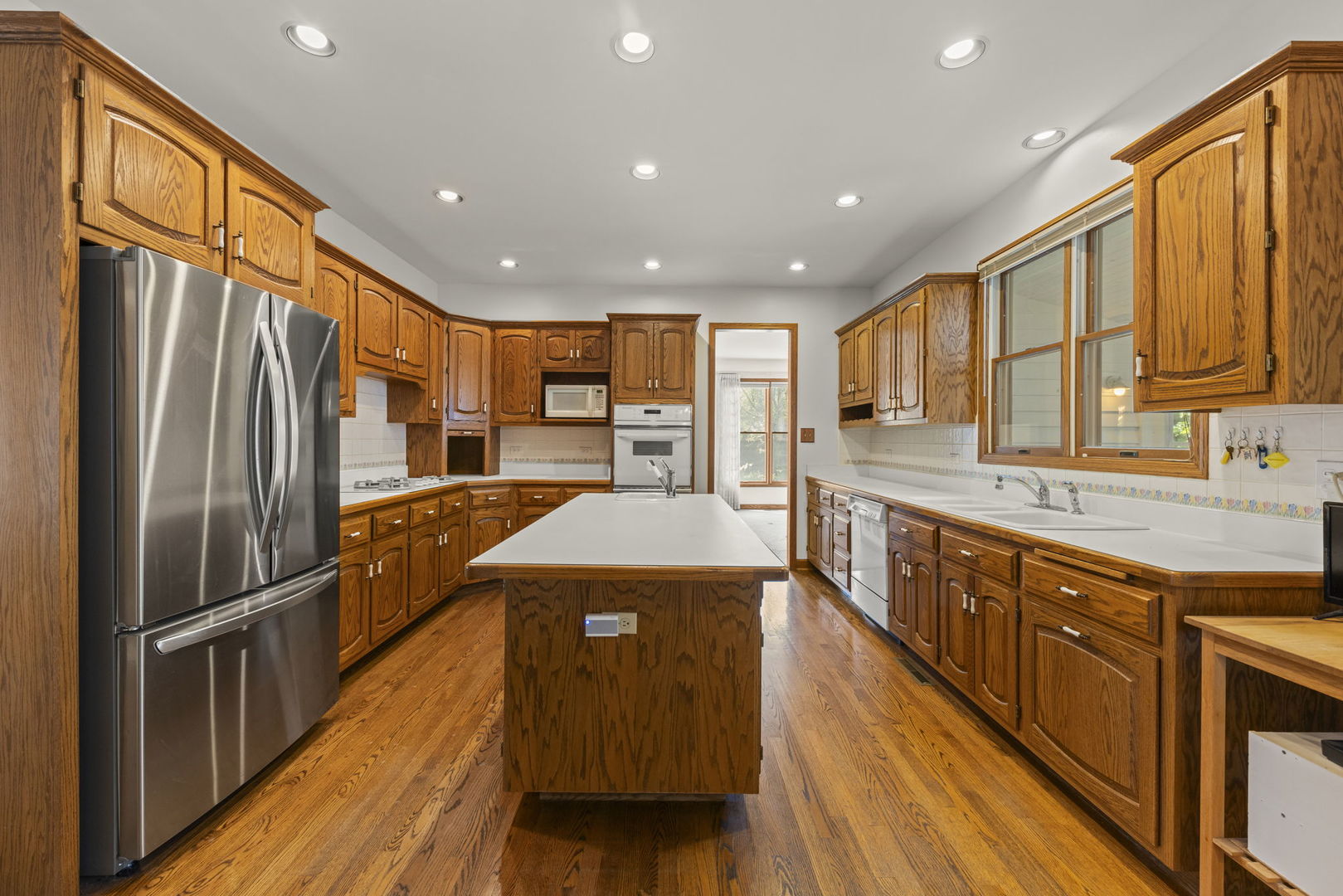 18040 Perth Avenue Homewood, IL 60430 - Photo 11 of 44 a kitchen with stainless steel appliances granite countertop a refrigerator a sink dishwasher a stove and a oven with wooden floor