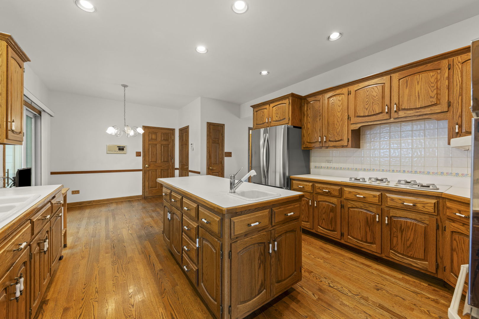 18040 Perth Avenue Homewood, IL 60430 - Photo 12 of 44 a kitchen with stainless steel appliances granite countertop a stove and a refrigerator