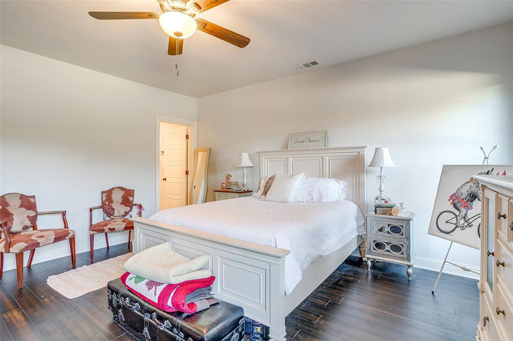 4920 Shining Star Trail Rio Vista, TX 76093 - Photo 30 of 39 a bedroom with a bed and a chandelier