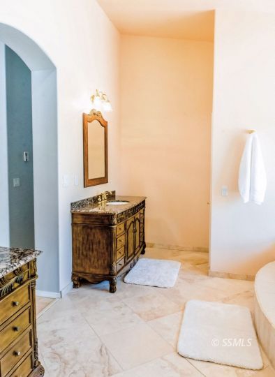 1652 Rademacher Way Ridgecrest, CA 93555 - Photo 7 of 16 a bathroom with a sink a toilet and mirror