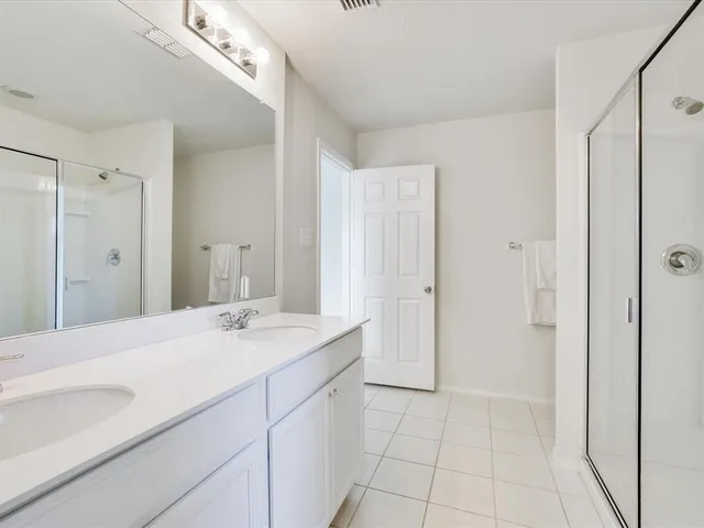 a bathroom with a shower and a glass door
