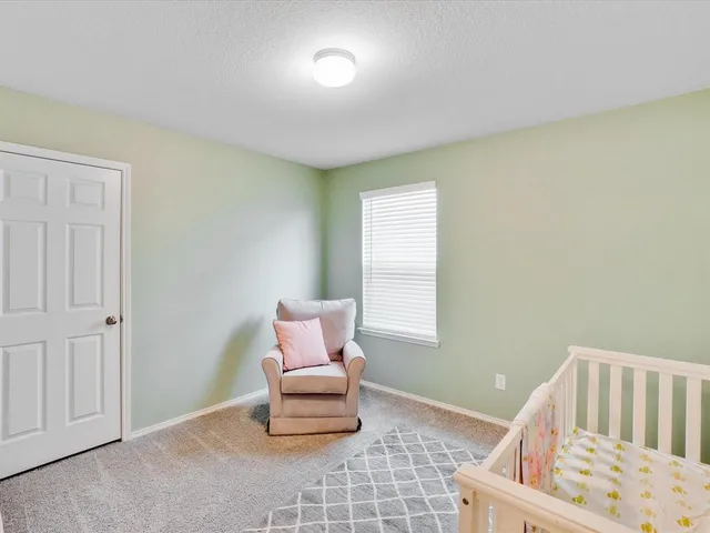 a bedroom with a bed and a table in it