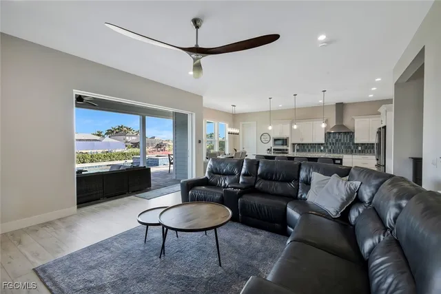a living room with furniture kitchen view and a table