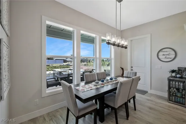 a large kitchen with kitchen island a stove a refrigerator a sink dishwasher with a dining table and chairs