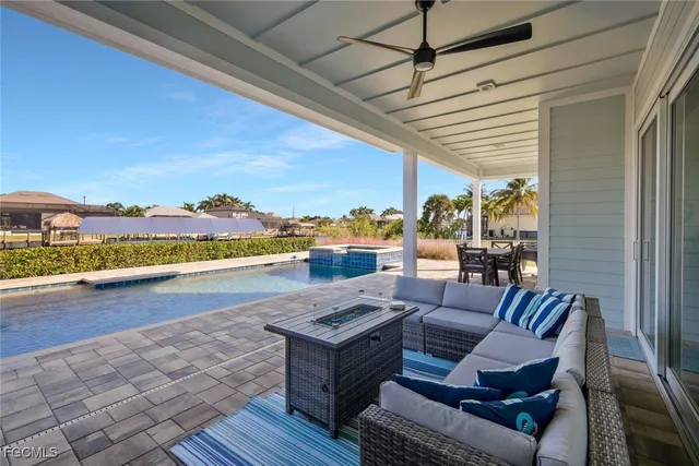a view of swimming pool with outdoor seating and plants