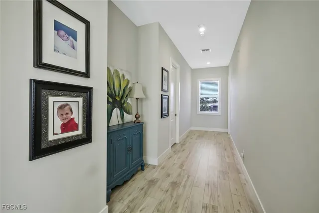 a spacious bedroom with a bed a window and a chandelier