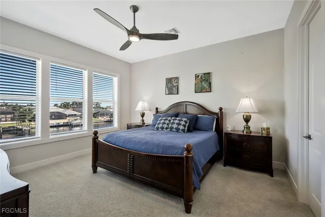 a bedroom with a bed and a flat tv screen on dresser