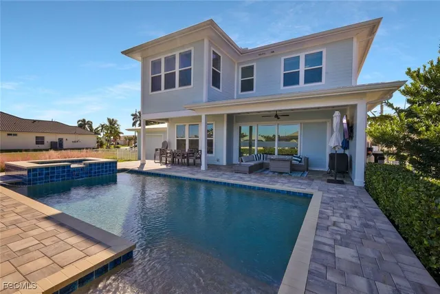 a view of a house with swimming pool and sitting area