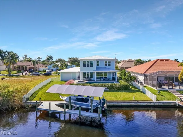 an aerial view of a house with swimming pool and outdoor seating