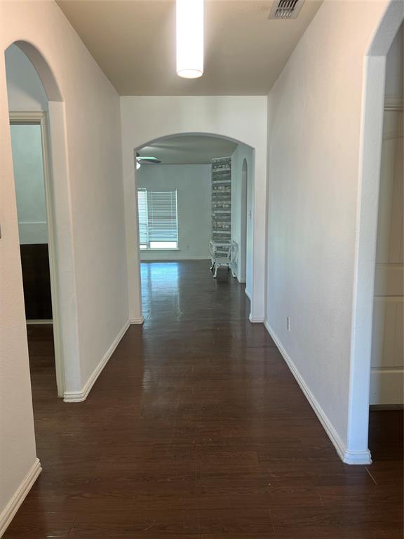 3144 Evangeline Road Fort Worth, TX 76140 - Photo 2 of 8 an empty room with wooden floor and windows