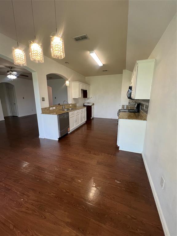 3144 Evangeline Road Fort Worth, TX 76140 - Photo 3 of 8 a living room with couches and kitchen view with wooden floor