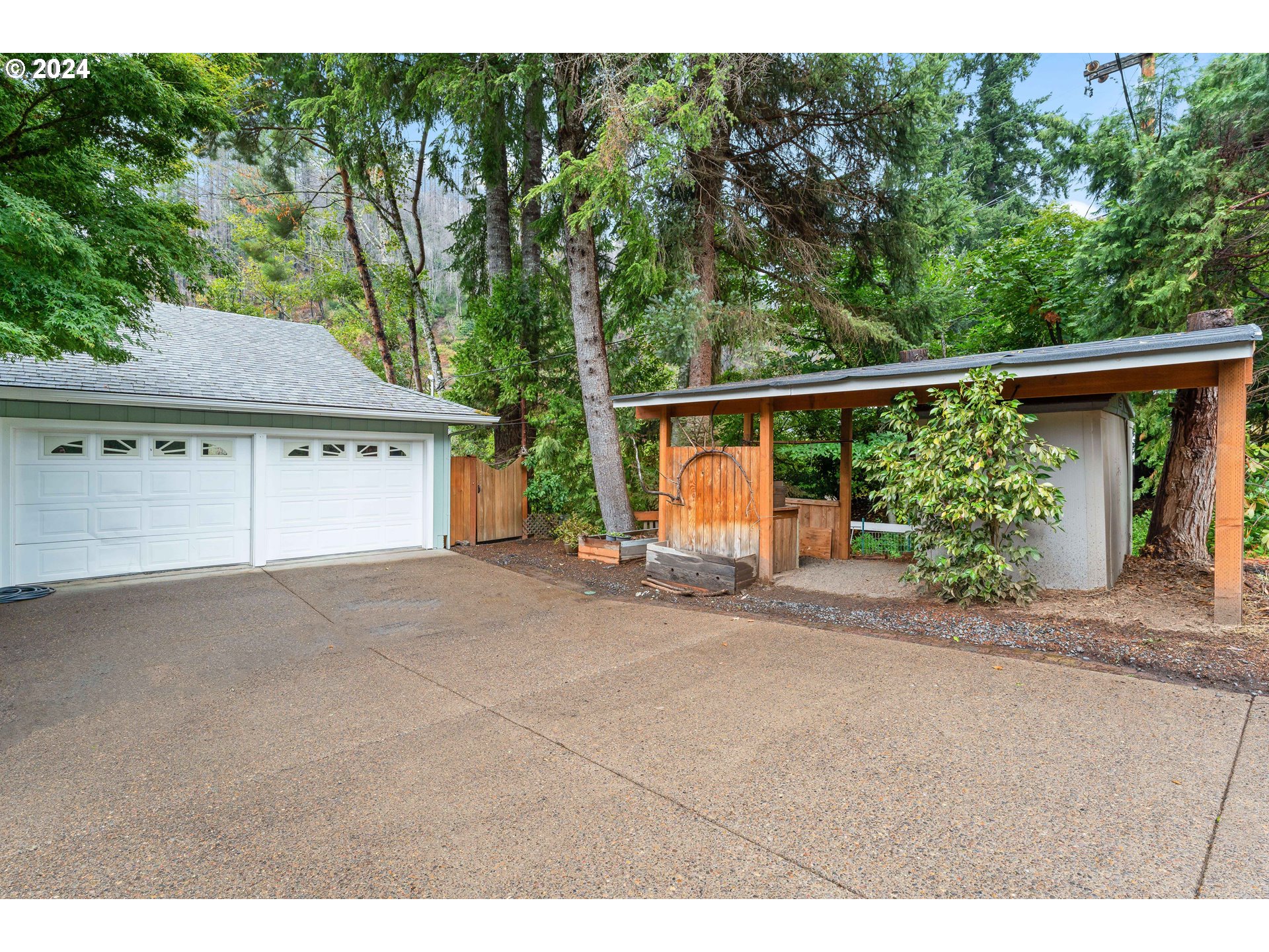 91070 Leashore Drive Vida, OR 97488 - Photo 41 of 43 a view of a house with a garden and pathway
