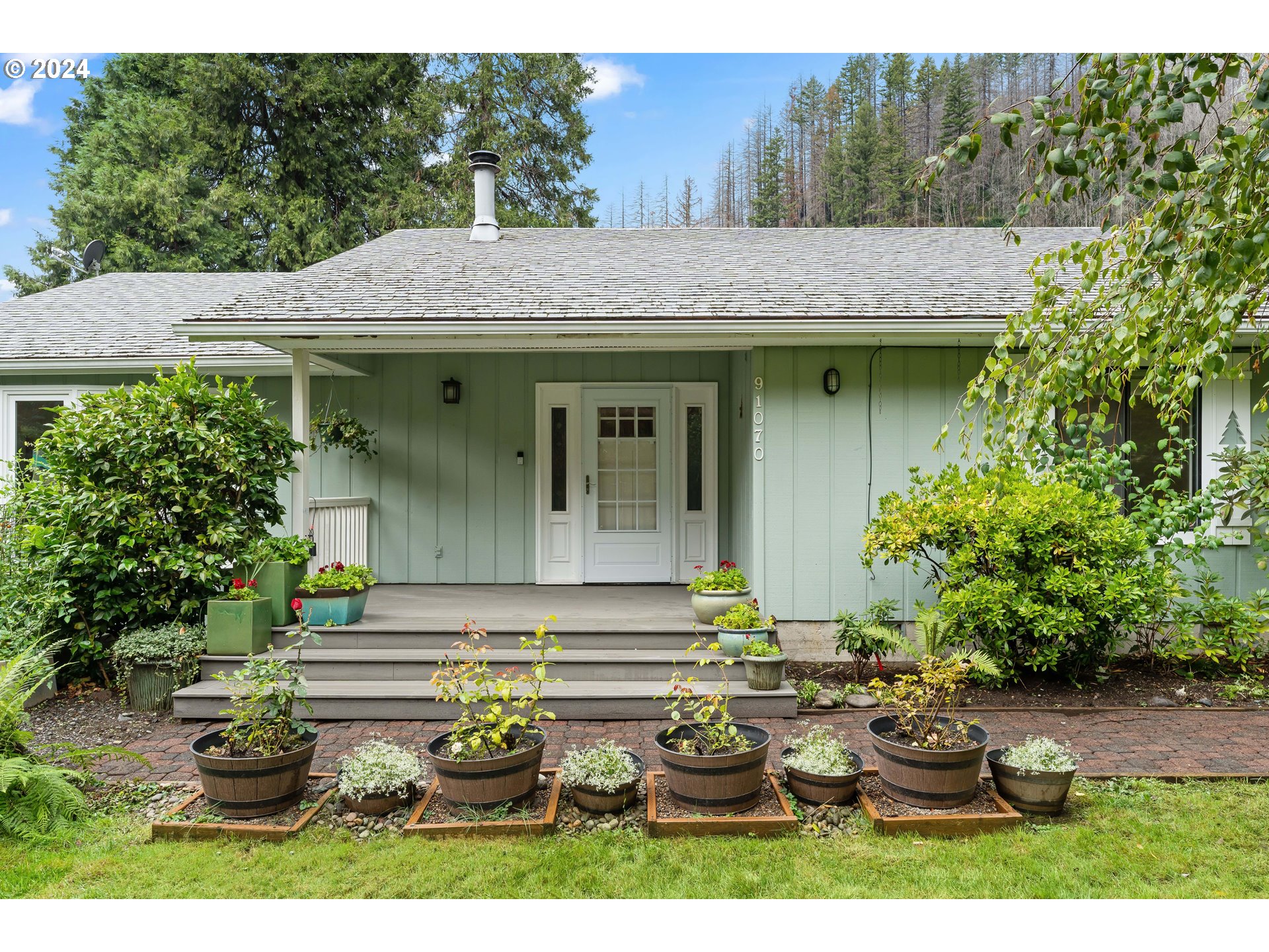 91070 Leashore Drive Vida, OR 97488 - Photo 43 of 43 a view of a white house with potted plants and a dining table
