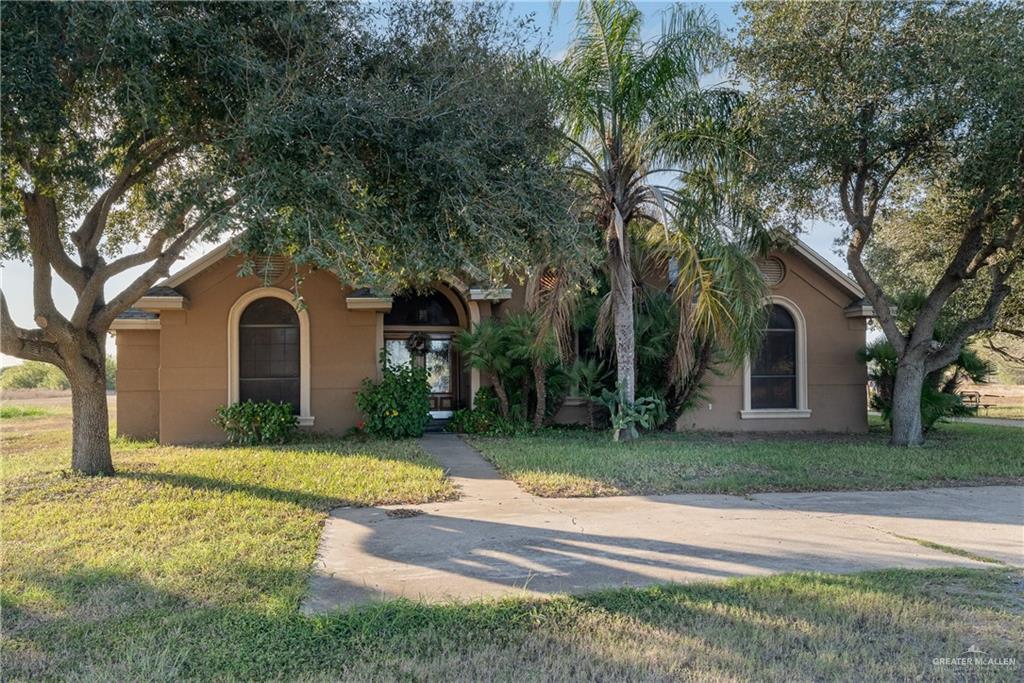 View of front of house with a front yard and stucco siding