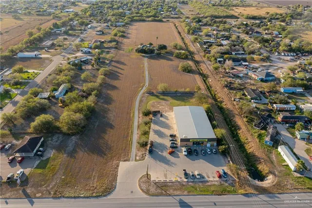 an aerial view of a house with a yard and lake view