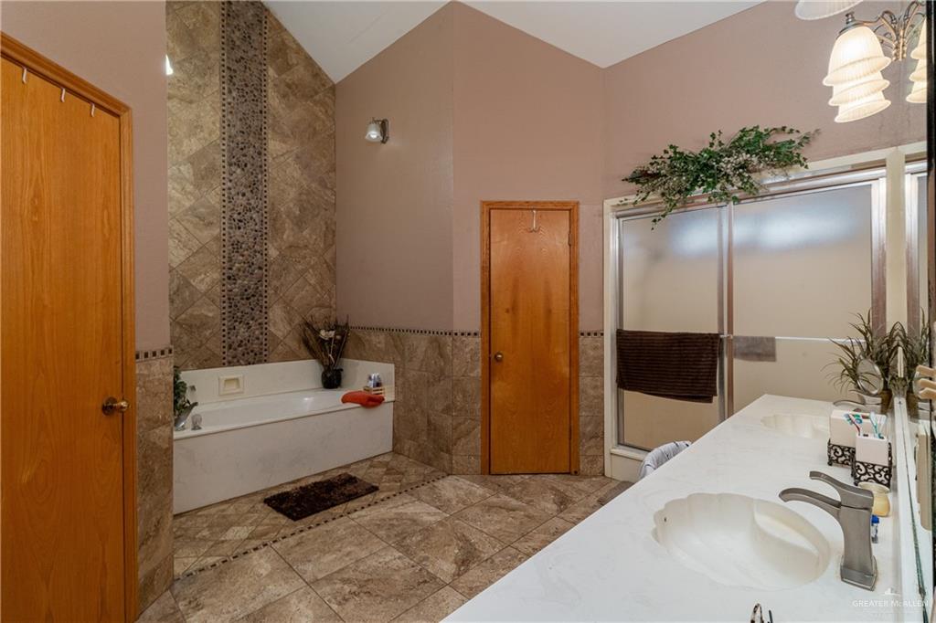 4112 Fm 493 Road Donna, TX 78537 - Photo 16 of 18 a bathroom with a sink a tub and a shower