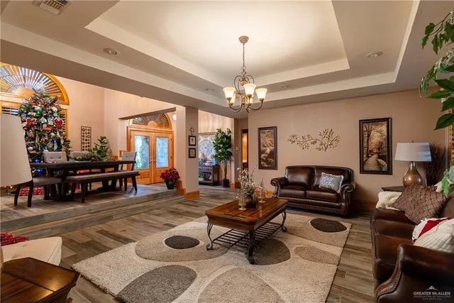a living room with furniture a rug and a chandelier