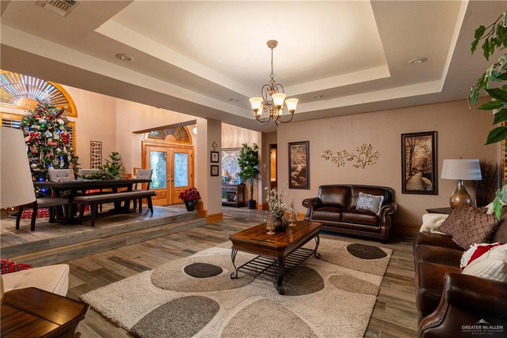 4112 Fm 493 Road Donna, TX 78537 - Photo 8 of 18 a living room with furniture a rug and a chandelier