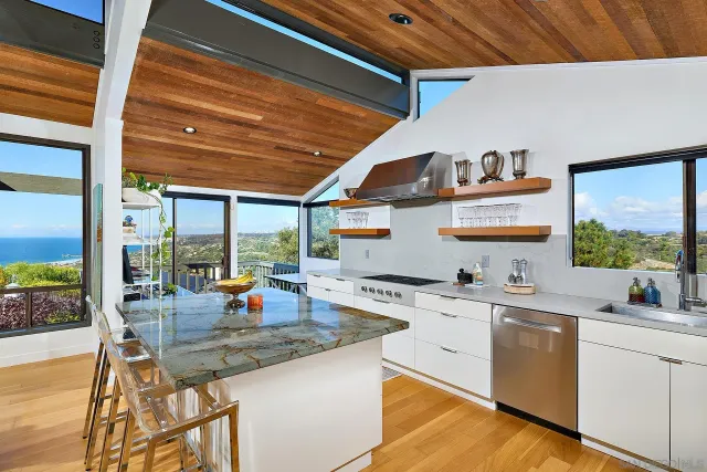 a kitchen with stainless steel appliances granite countertop a sink a stove and a refrigerator