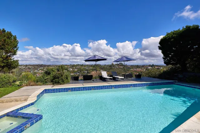 a bedroom with a bed a flat screen tv and a chandelier