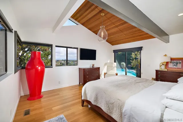 a bedroom with a large bed and a window