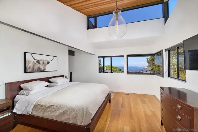 a bedroom with a large bed and a window