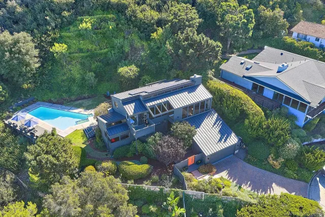 an aerial view of a house with a yard and garden