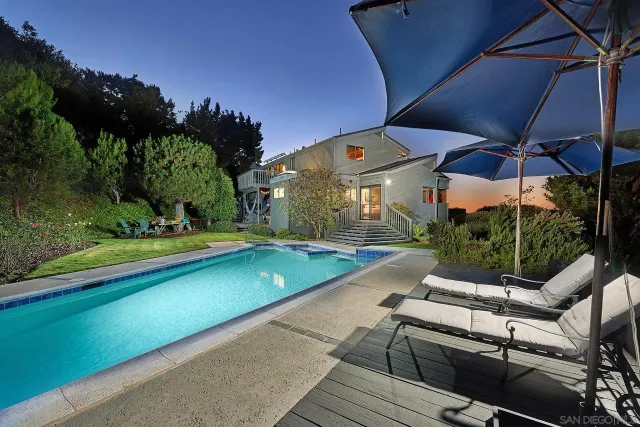an outdoor space with swimming pool table and chairs