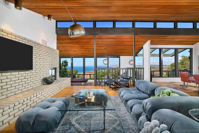 a view of a backyard with a large window and potted plants