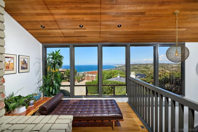 a balcony with furniture and a fireplace